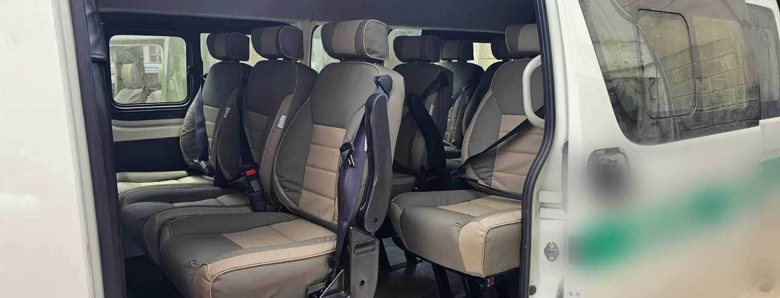 Beige seats with seat belts fitted in a white van