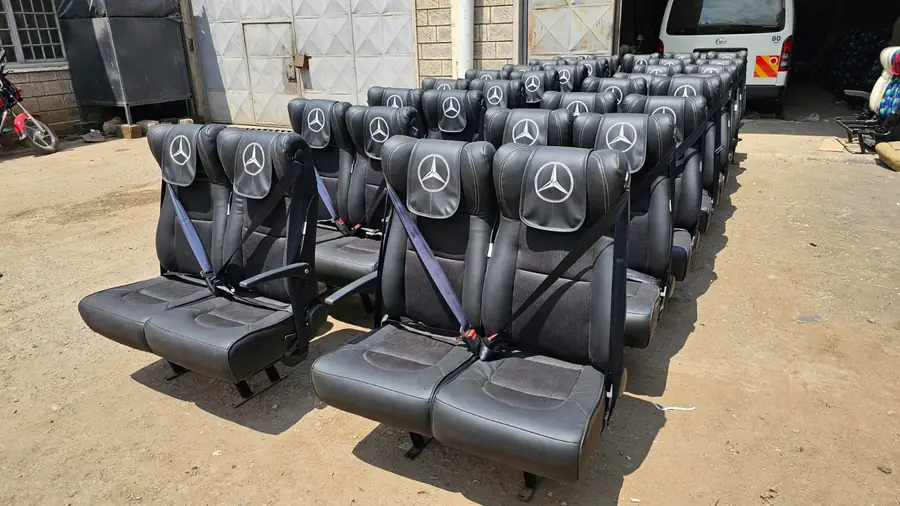 Bus seats with Mercedes-Benz headrests and seat belts in the workshop yard