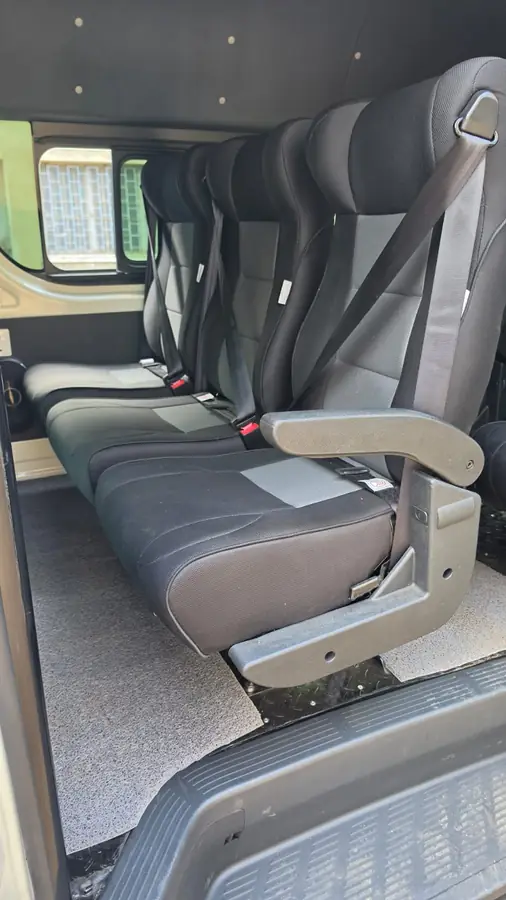Executive seats with an armrest and seat belts fitted in a van