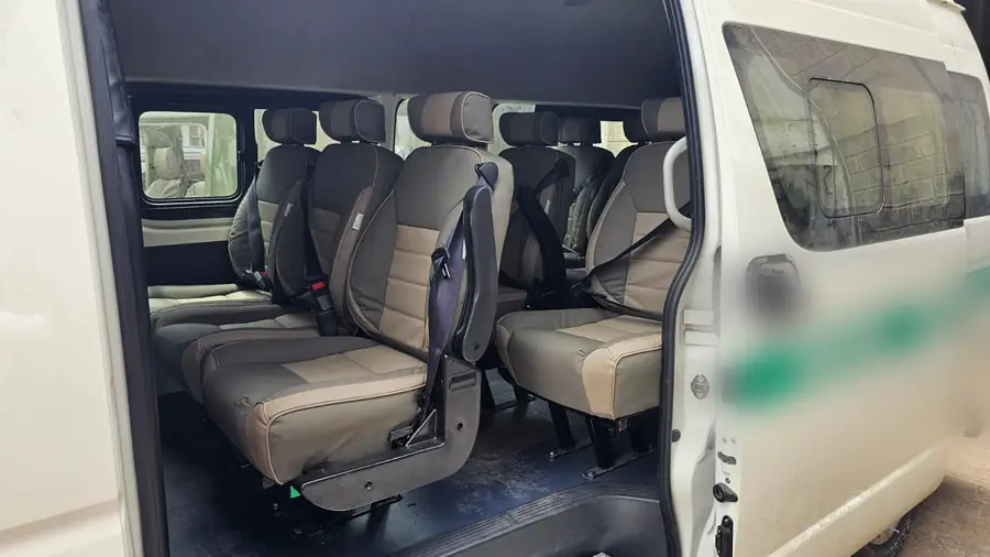 Beige seats with seat belts fitted in a white van