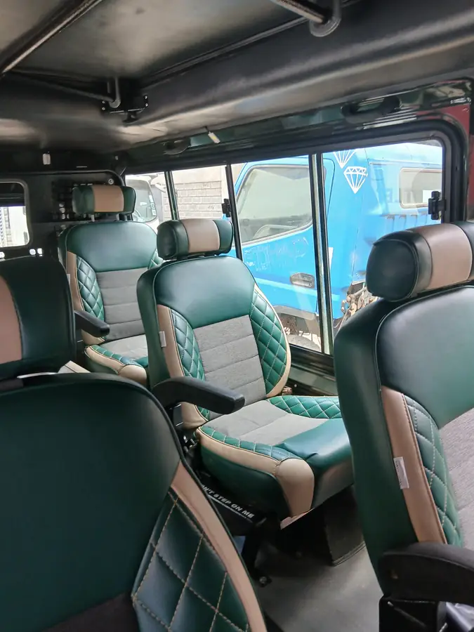 Cabin fitted with green and grey diamond-stitch seats