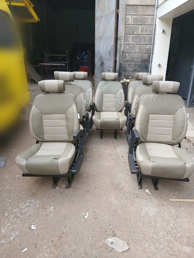 Beige two-tone Land Cruiser seats lined up in the workshop