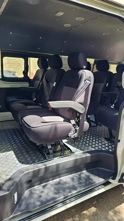 Dark grey seats fitted in a van with a chequer-plate floor