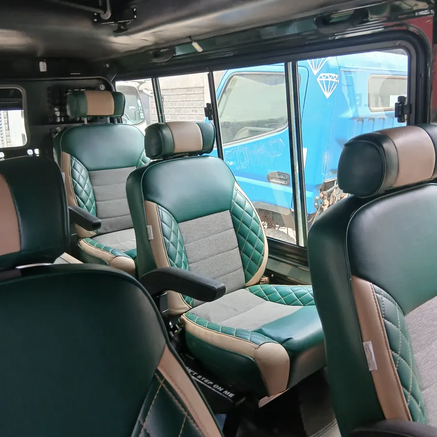 Green and grey diamond-stitch captain seats fitted in a vehicle cabin