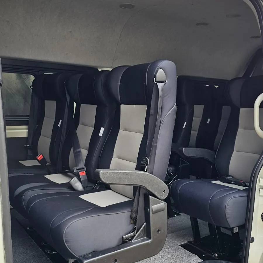 Grey and black executive seats with armrests fitted inside a van