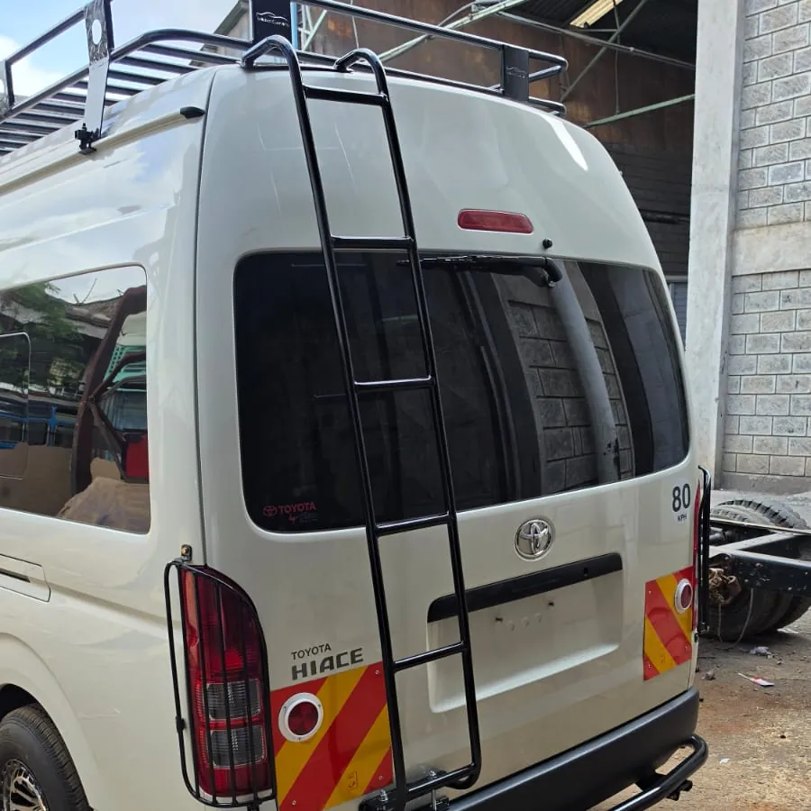 Rear of the same Hiace with roof rack, ladder, tail-light guards and rear bumper guard
