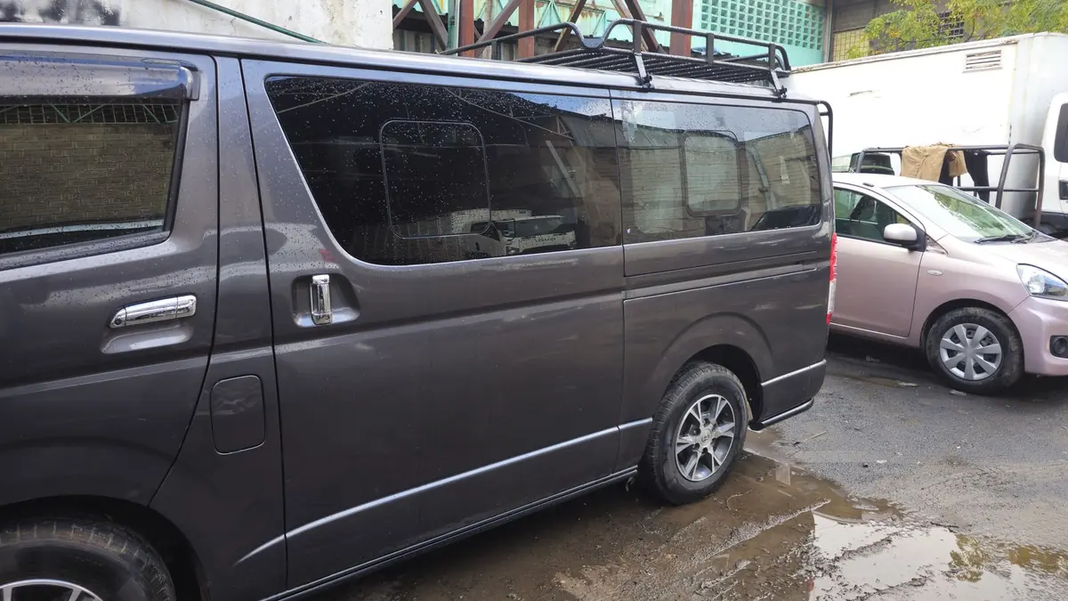 Toyota Hiace with a roof rack outside the workshop