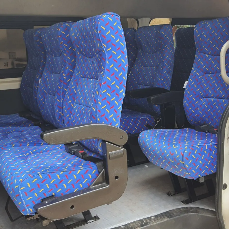 Blue patterned standard seats with an aisle armrest fitted in a van